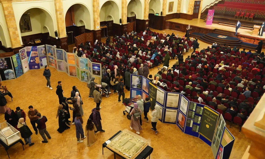 Rows of illustrated Exhibition Islam display panels in a busy hall