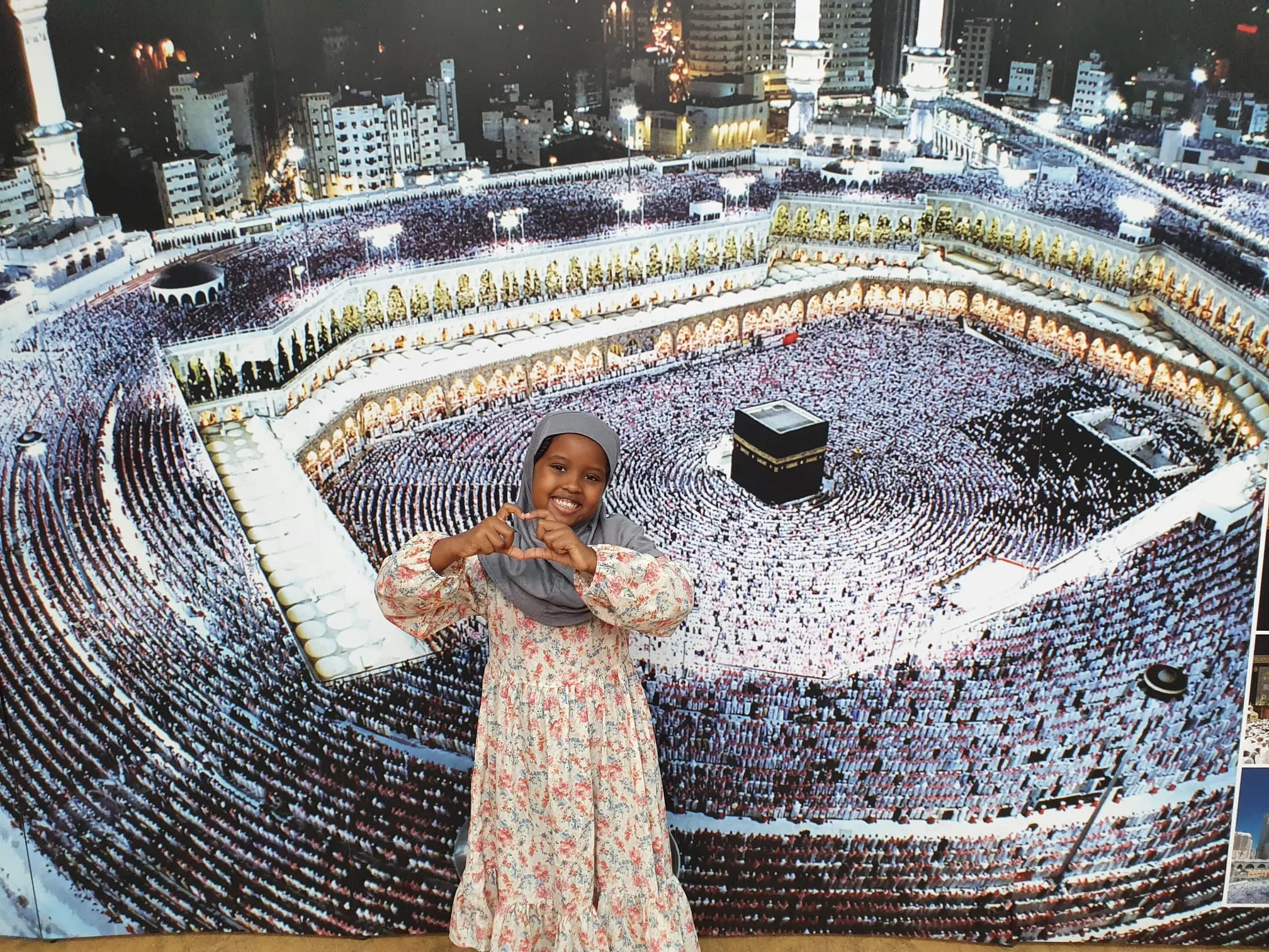 A child stands on a floor print of the Haram in Makkah at an Exhibition Islam event