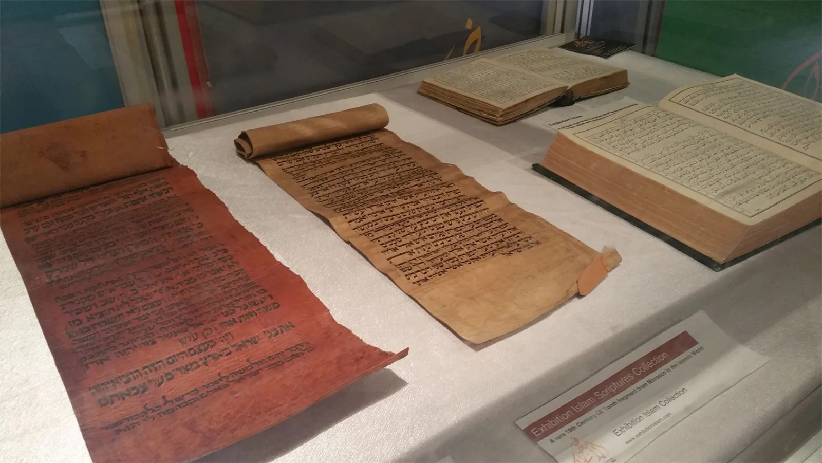 Handwritten manuscripts and scrolls in a display case