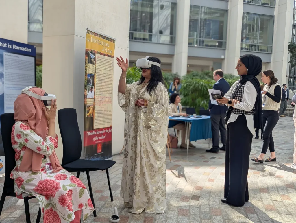 An Exhibition Islam volunteer guiding a visitor through a VR headset